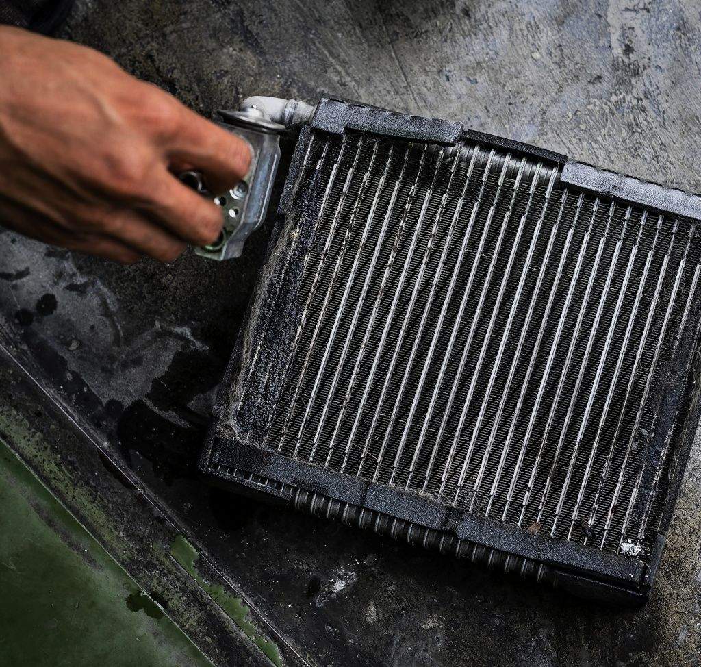 Evaporator coil from a car is leaking refrigerant onto the floor