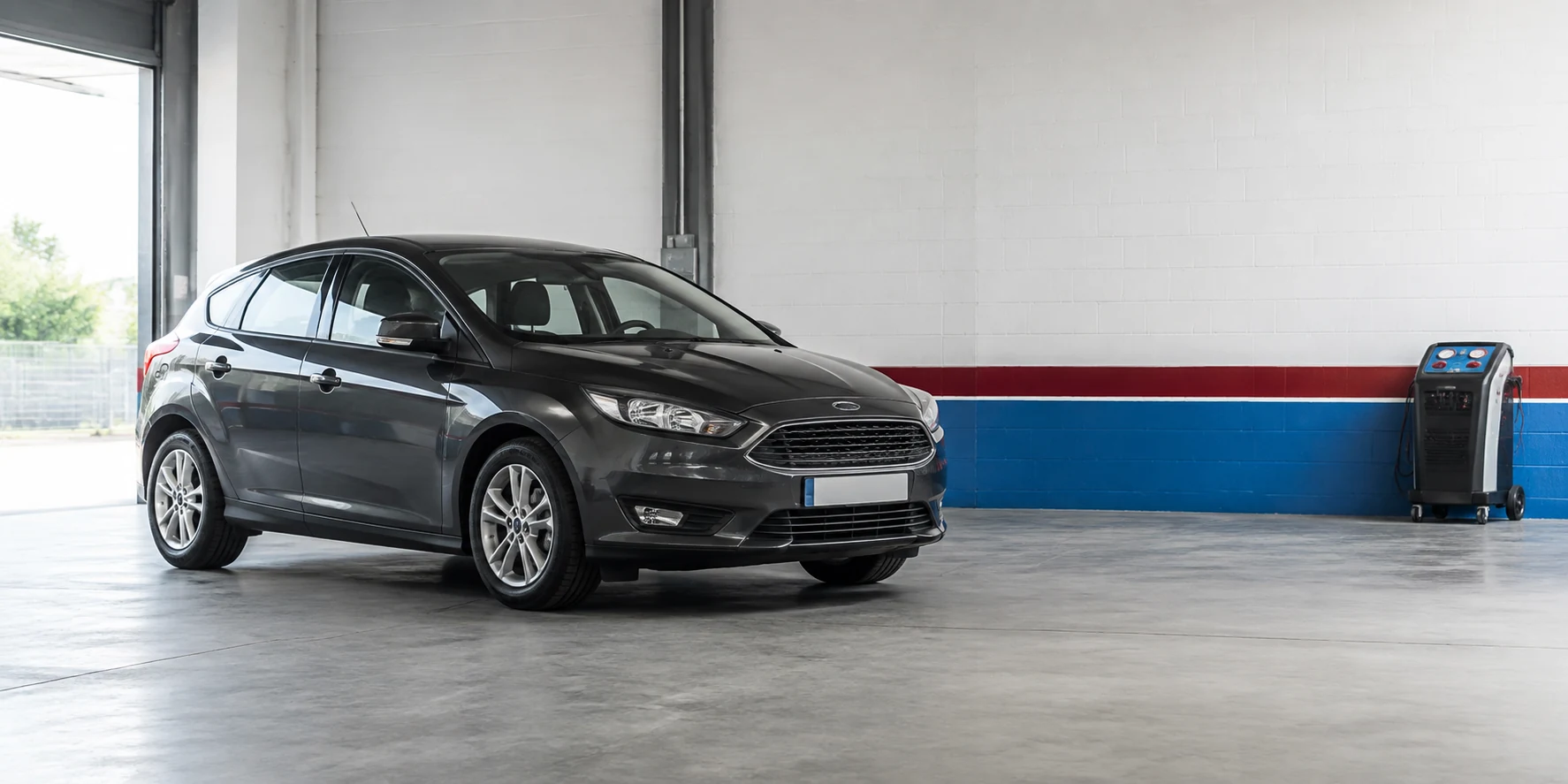 Car in a clean garage bay for air conditioning service